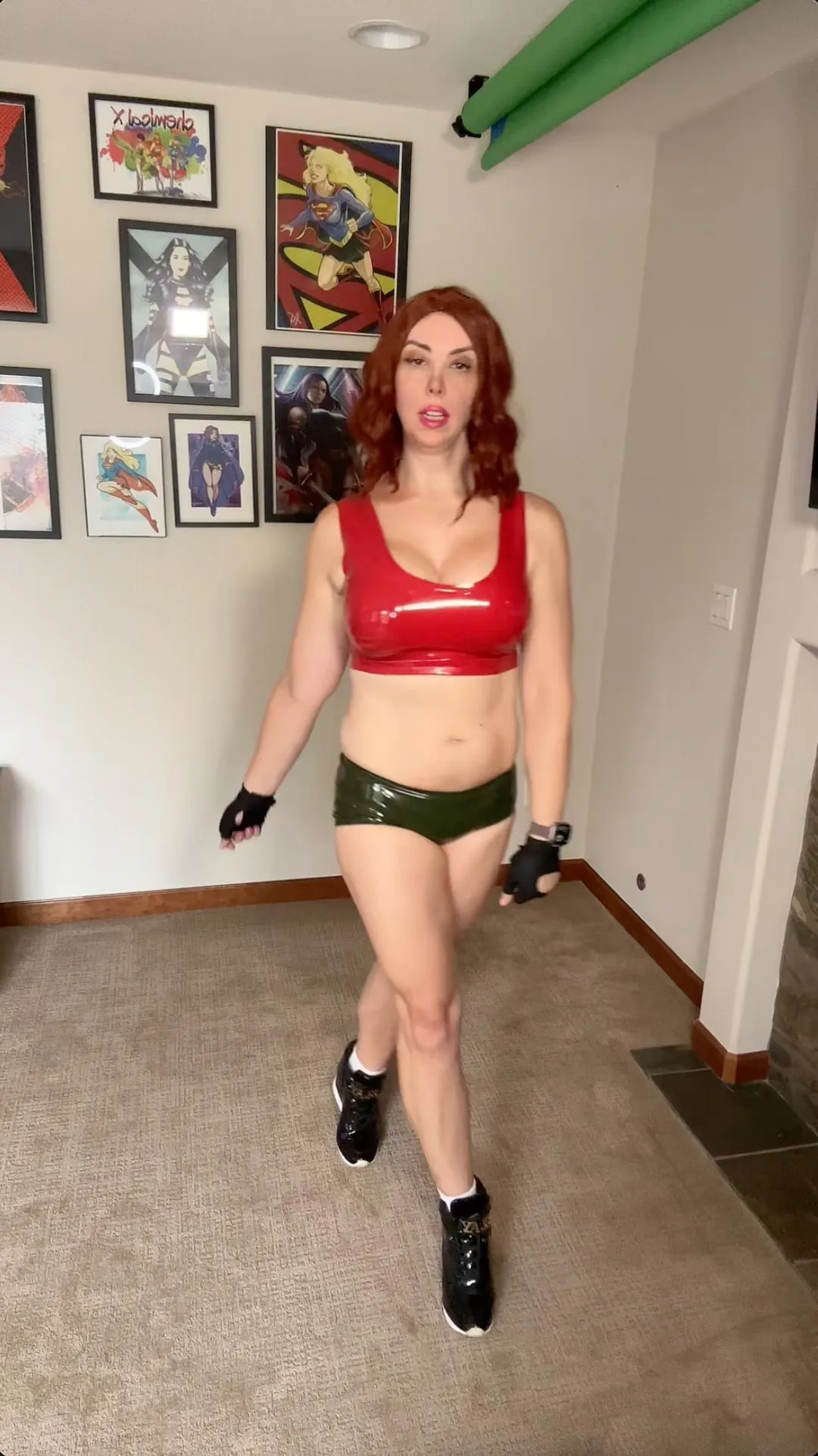 Jerikandra as Ruby Roundhouse from Jumanji: Welcome to the Jungle in a red crop top, green shorts and fingerless gloves.