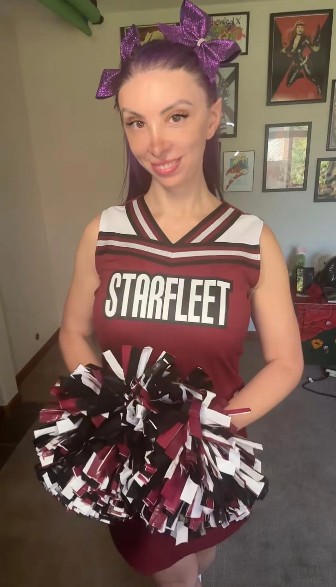 Jerikandra in a Star Trek cheerleader costume with a Starfleet top, pointed ears and maroon and white pom-poms.